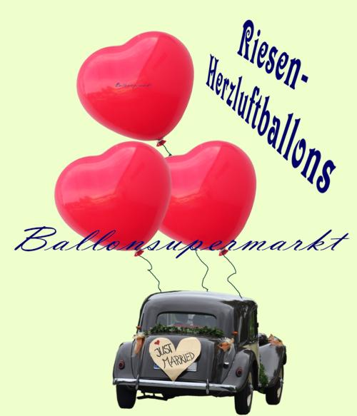 Hochzeitsauto mit roten Riesen-Herzluftballons